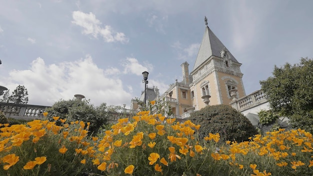 Beautiful facade of massandra palace in crimea action close up of blooming orange flowers with the