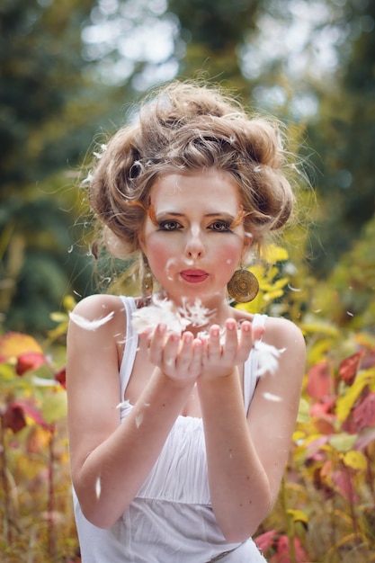 Beautiful fairy girl posing in a forest