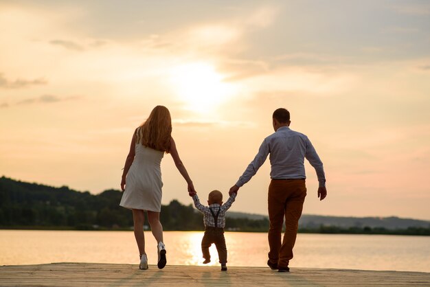 Beautiful family having fun near the lake