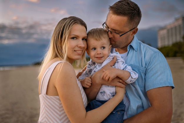 beautiful family on sunset on beach