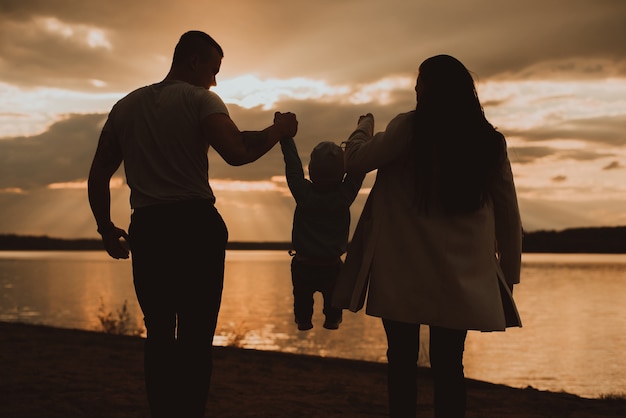 Beautiful family with their son near a river