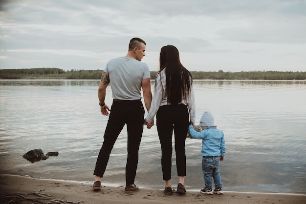 Beautiful family with their son near a river