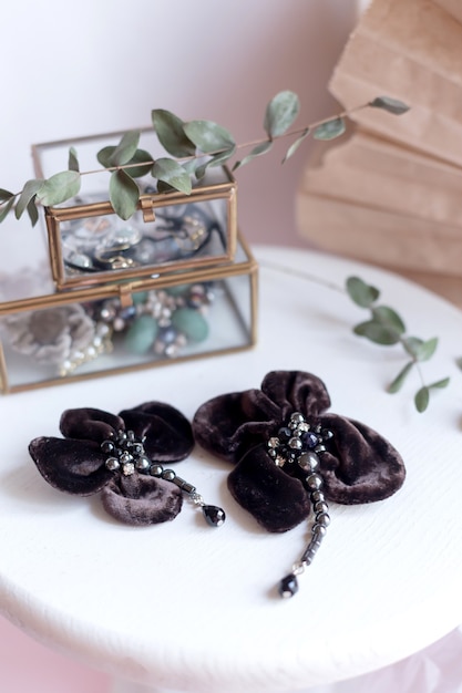 Beautiful fashion accessory. Handmade accessories brown brooch on white and brown background