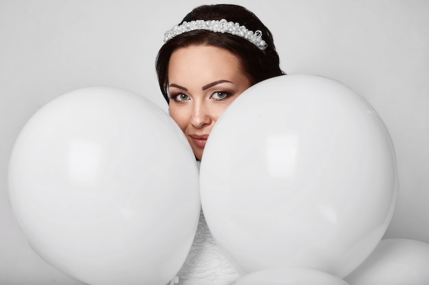 Beautiful fashion model girl with white balloons