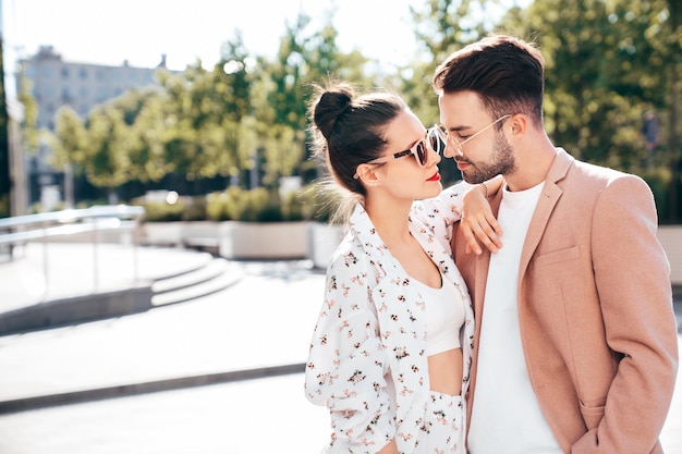 beautiful fashion woman and her handsome elegant boyfriend in beige suit outdoors