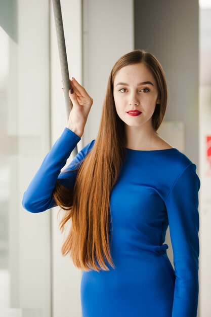 Beautiful fashion woman standing near window