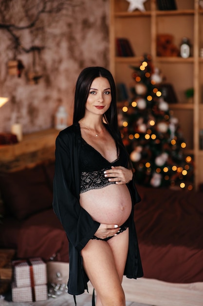 Beautiful fashionable pregnancy woman posing with a large belly Pregnant sexy woman in hat