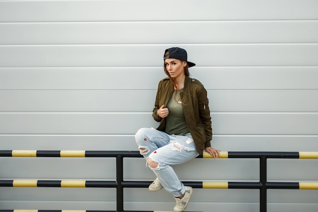 Beautiful fashionable woman in stylish street clothes with a baseball cap