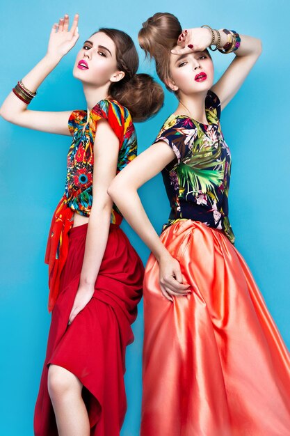Beautiful fashionable women an unusual hairstyle in bright clothes and colorful accessories