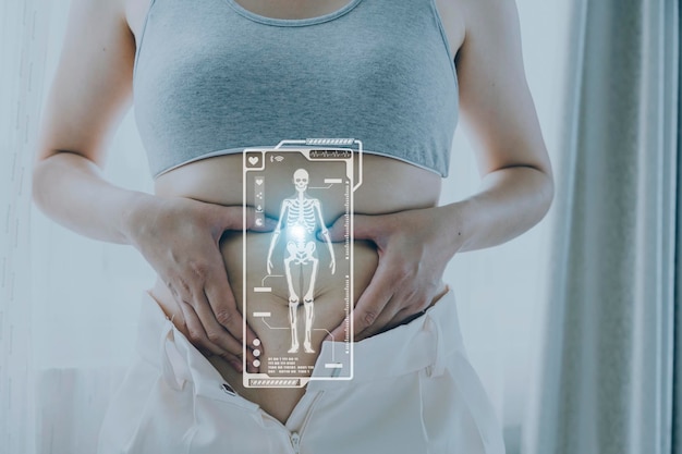 Beautiful fat woman with tape measure She uses her hand to squeeze the excess fat that is isolated on a white background She wants to lose weight the concept of surgery and break down fat under the