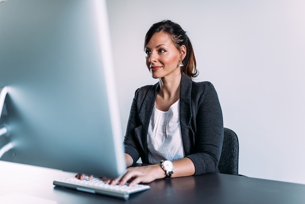 Beautiful female administrator working on a computer. 