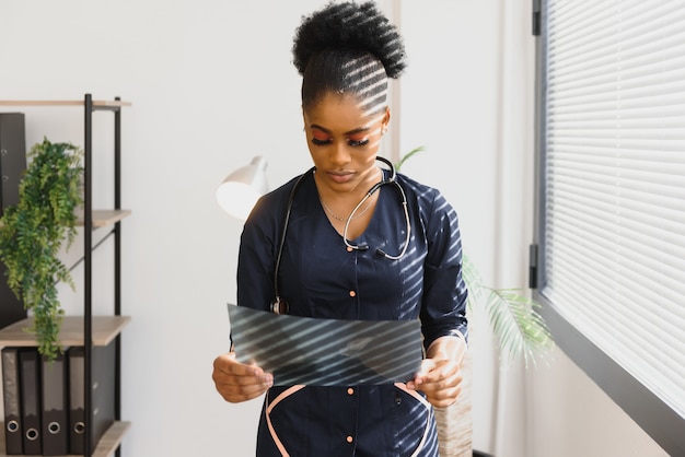 Beautiful female african medical worker holding x-ray