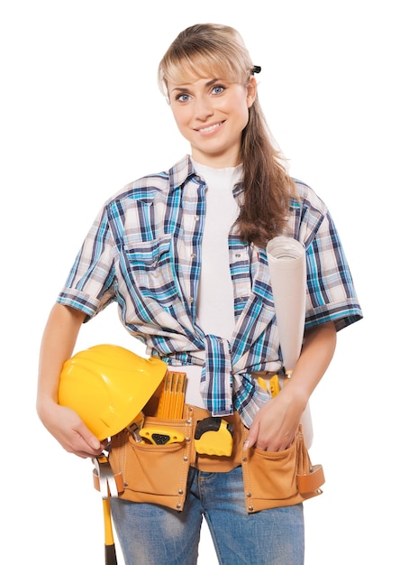 Beautiful female construction worker holding hardat and blueprin