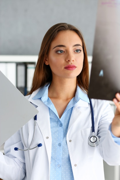 Beautiful female doctor hold in arm xray picture