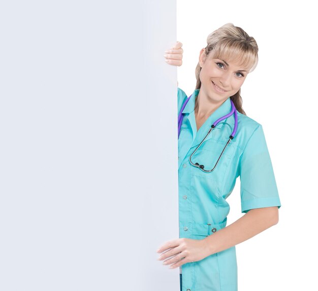 Beautiful female doctor holding white placard