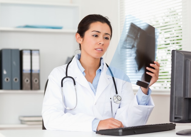 Beautiful female doctor looking at a x-ray