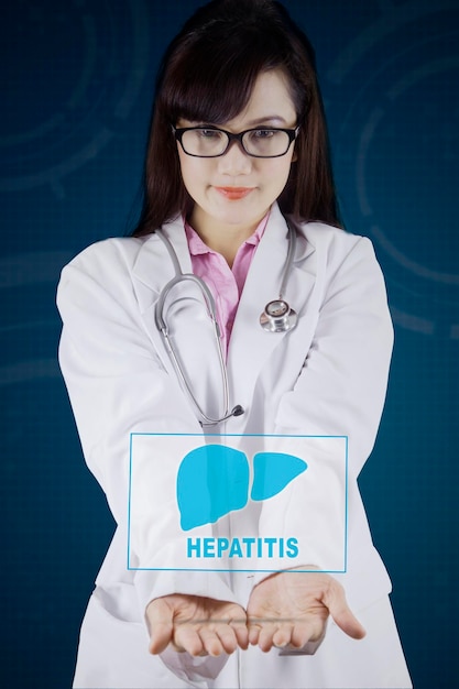 Beautiful female doctor showing liver symbol