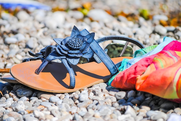 Beautiful female flip flops on the shore of the Adriatic Sea.