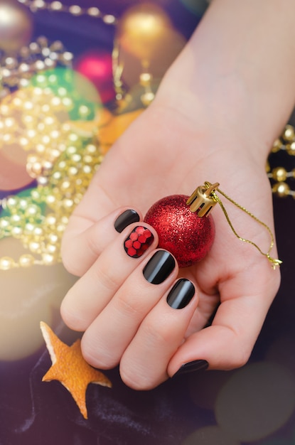 Beautiful female hand with christmas nail design