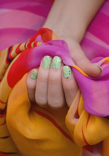 Beautiful female hand with green nail design