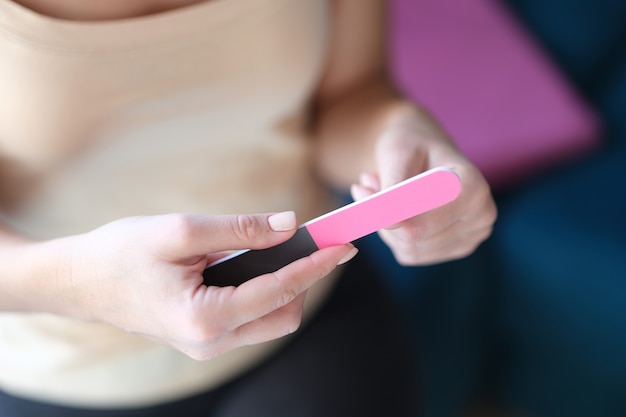 Beautiful female hands holding a nail file