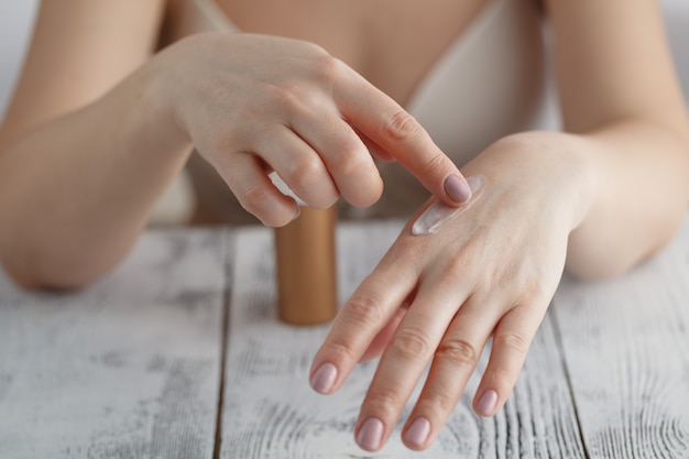 Beautiful female hands with cream