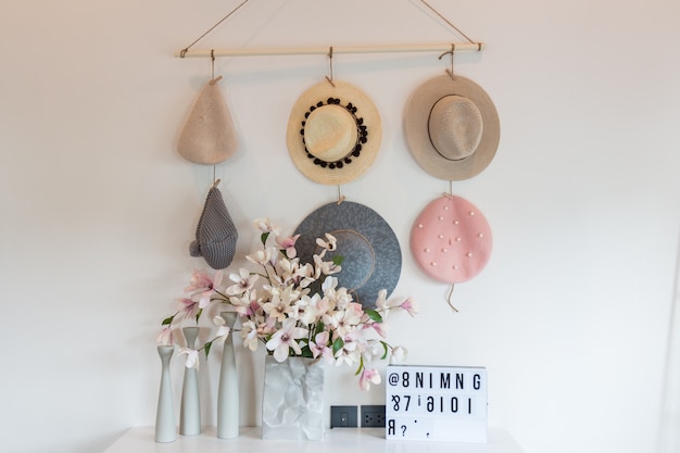 Beautiful female hat hanging on rope fabric