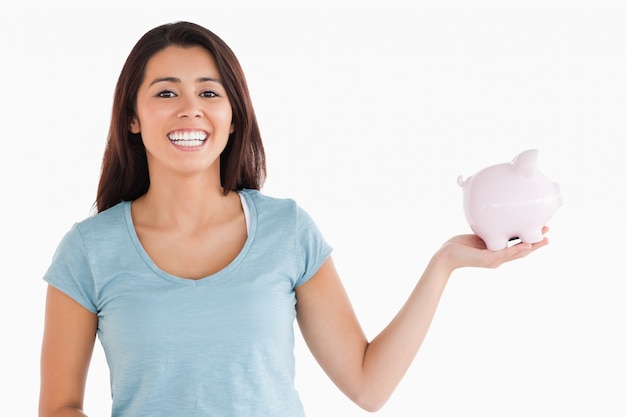 Beautiful female holding a piggy bank