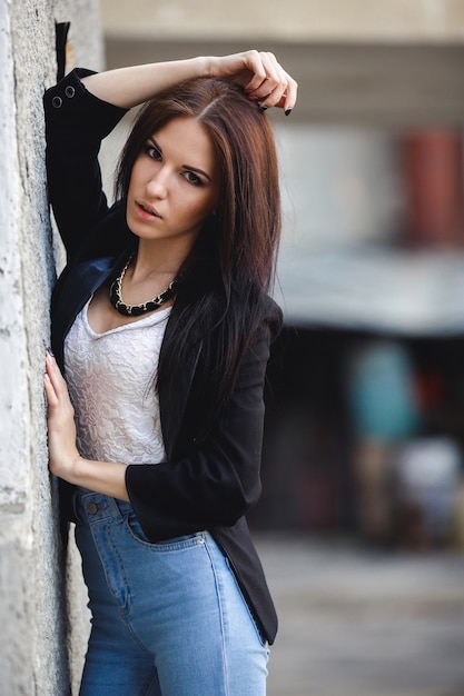 Beautiful female model posing against the wall