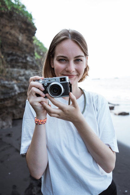 Beautiful female photographer on the beach