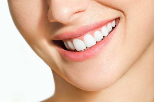 Beautiful female smile after teeth whitening procedure. Dental care. Dentistry concept