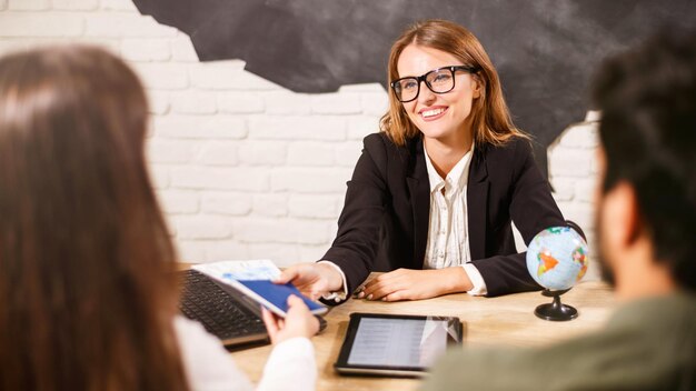 Beautiful female travel agent in glasses