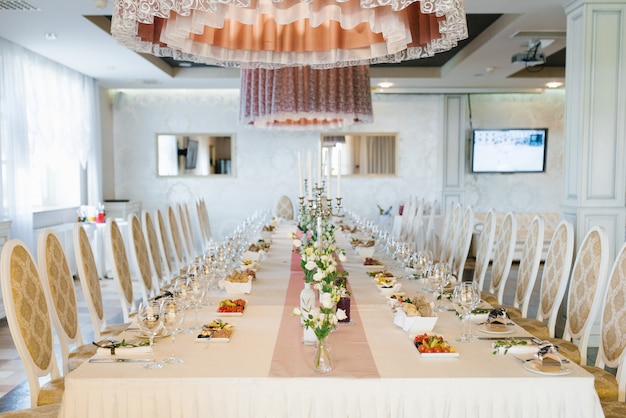 Beautiful festive Banquet wedding table with bouquets of white eustoma