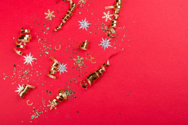 Beautiful festive red background with sparkles and Christmas golden toys