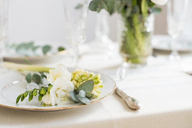 Beautiful festive table setting with elegant white flowers and cutlery dinner table decoration