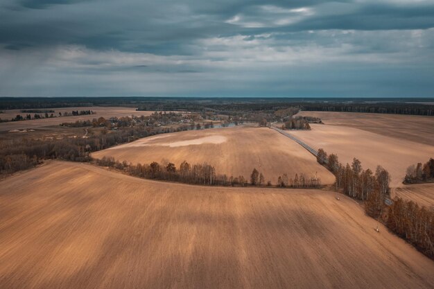 Photo beautiful fields in autumn from height under beautiful sky belarus