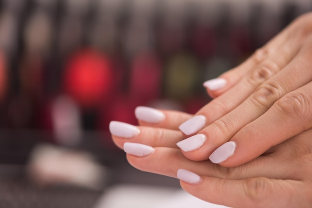 Beautiful fingers with french manicure on the towel. Manicure in a beauty salon.