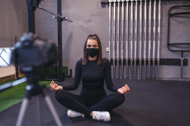 A beautiful fit woman shoots a workout on camera