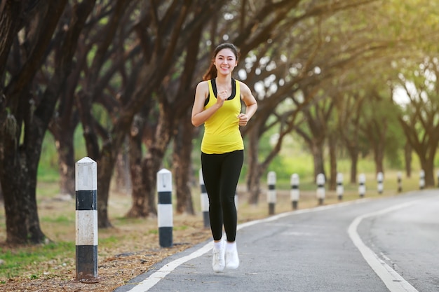 beautiful fitness woman running in park