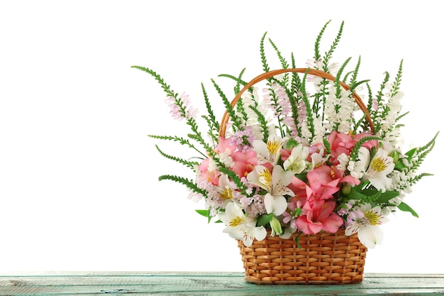 Beautiful floral arrangement in basket isolated on white