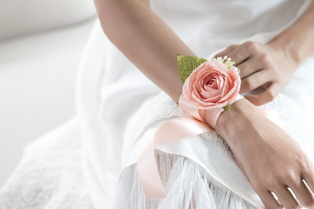 Beautiful flower bracelet on bridesmaid's hands.