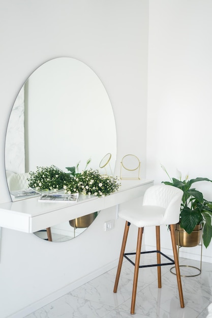 Beautiful flower branches on dressing table in room interior design