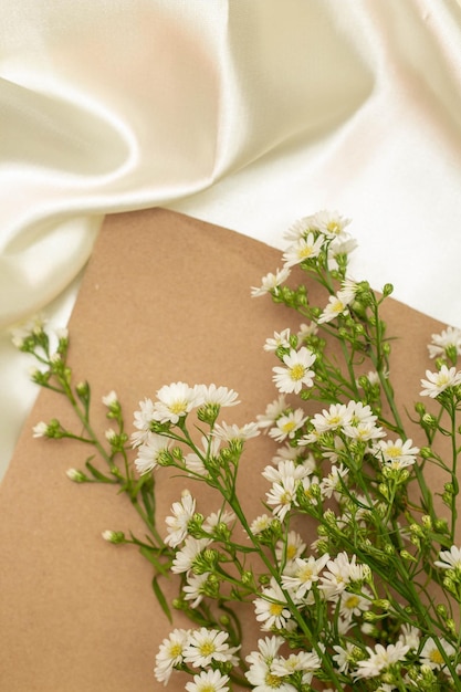 Beautiful flower concept Bouquet of white blooming cutter flower with brown paper on white cloth