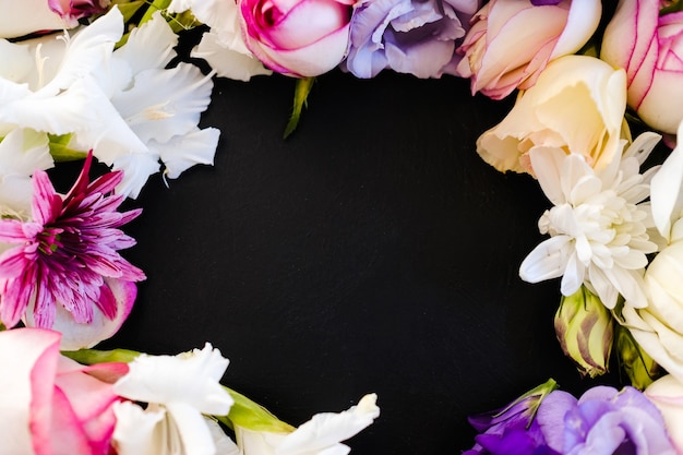 Beautiful flowers frame on dark background