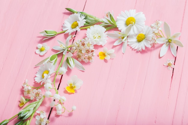 Beautiful flowers on pink wooden