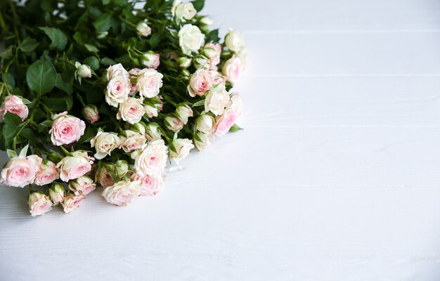 Beautiful flowers on white background. Roses bouquet. Perfect flat lay. Happy mother's holiday postcard. International women's day greeting. Stylish idea for advert or promotion.