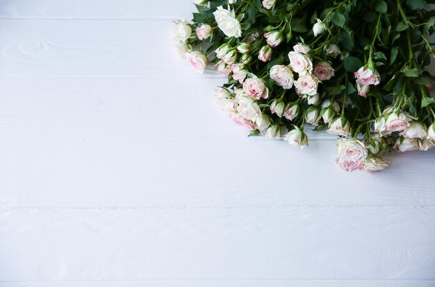 Beautiful flowers on white background. Roses bouquet. Perfect flat lay. Happy mother's holiday postcard. International women's day greeting. Stylish idea for advert or promotion.