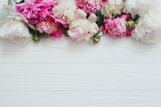 beautiful flowers on white wooden background