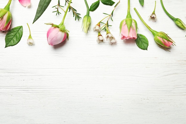 Beautiful flowers on wooden background