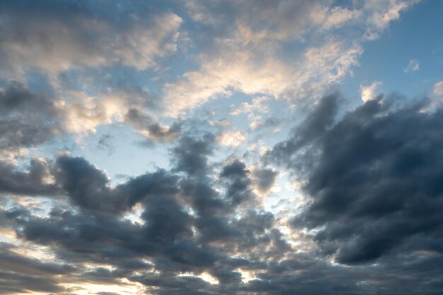 Beautiful fluffy clouds in the evening sky The sunlight gives a side light on the clouds Clouds before rain